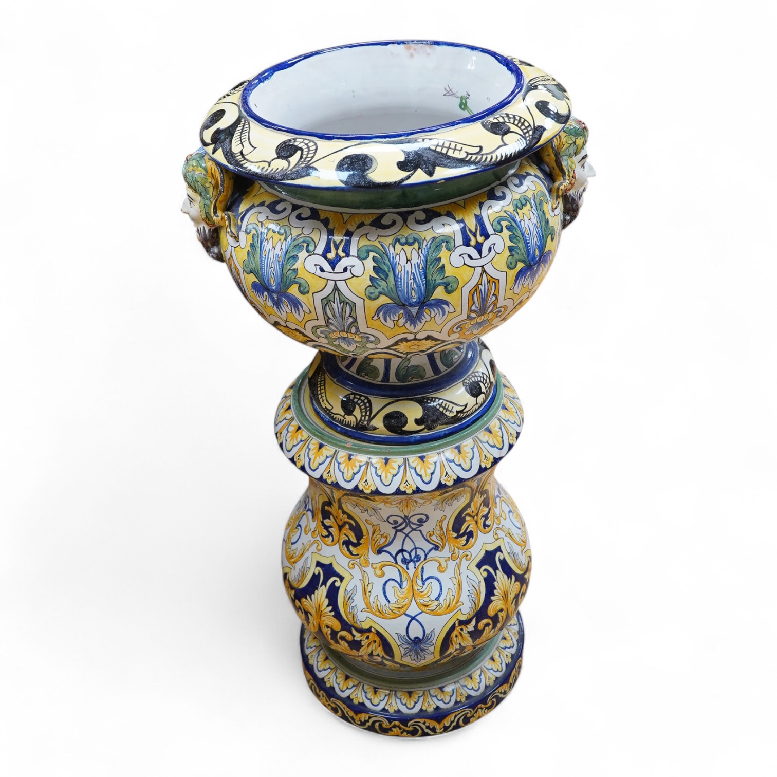 A tall decorative French faience pottery jardiniere with Bacchus mask mounts and a similar associated stand